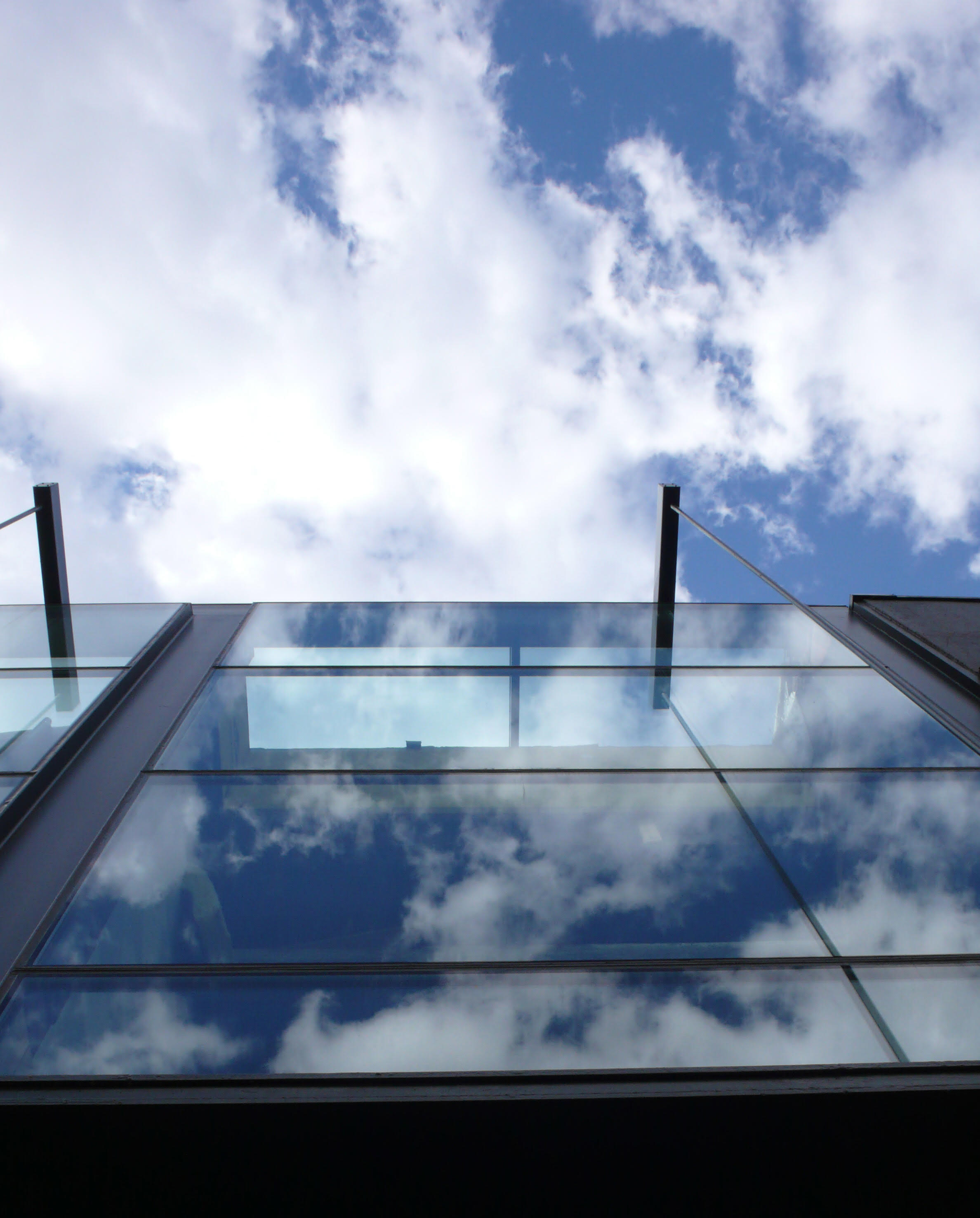 Glass facade reflecting clouds